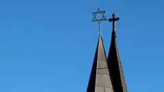 Side by side spires with cross and star of david